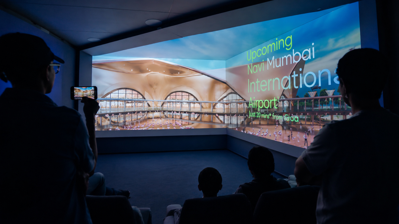 Visitors watch an immersive projection of the upcoming Navi Mumbai International Airport inside a digital experience room